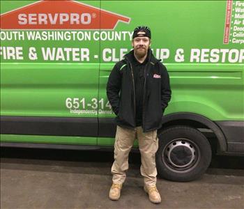 cyrus posing in front of servpro truck