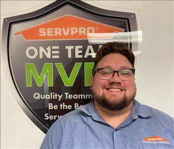 SERVPRO employee in front of green background