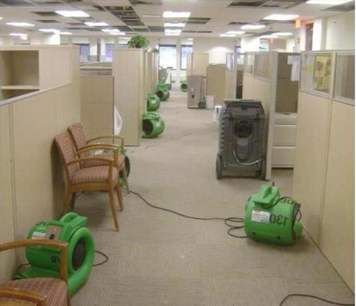 equipment down long office alley with cubicles on both side