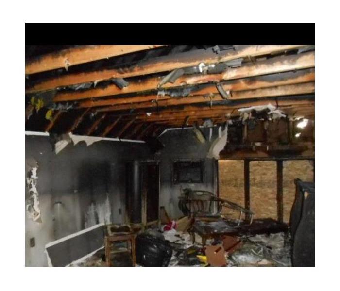 debris in fire-damaged room boarded up sliders