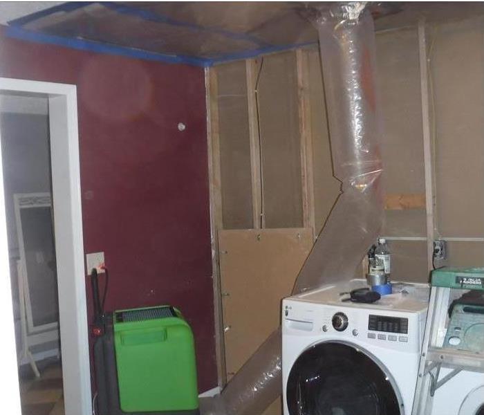 dehu and flex duct into attic, washing machine shown